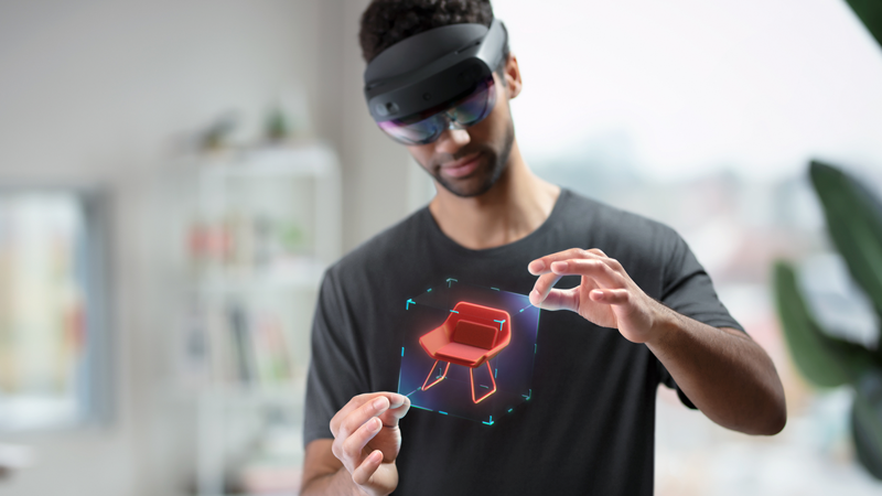 man uses mixed reality headset to display 3d model of furniture