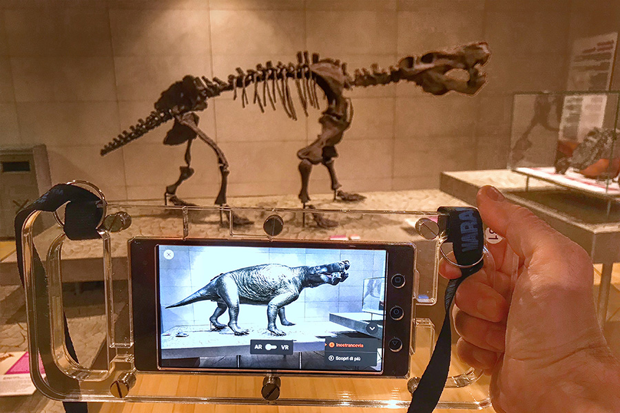 visitor uses mobile augmented reality to see extinct animal