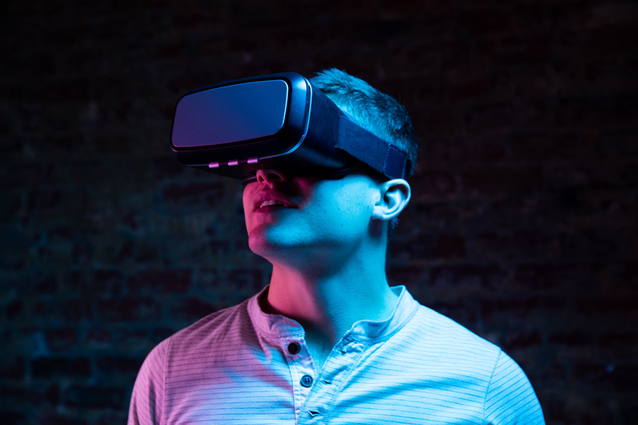 Man wearing a virtual reality headset in moody light