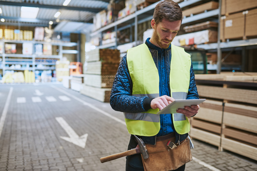 warehouse worker uses mobile app to manage inventory